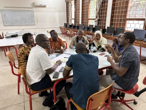 Researchers at a round table discussing an action plan